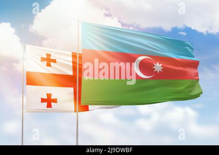 Sunny blue sky and flags of azerbaijan and georgia Stock Photo