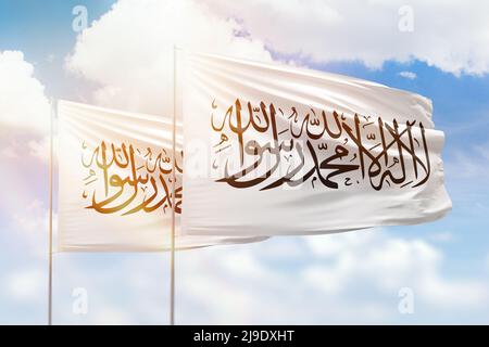 Sunny blue sky and flags of afghanistan and afghanistan Stock Photo