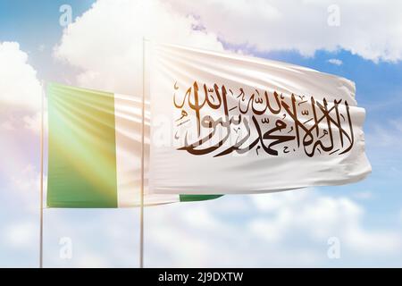 Sunny blue sky and flags of afghanistan and nigeria Stock Photo