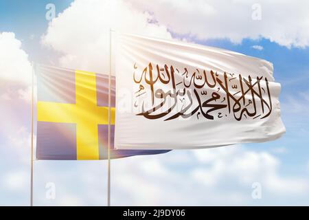 Sunny blue sky and flags of afghanistan and sweden Stock Photo