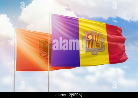 Sunny blue sky and flags of algeria and albania Stock Photo