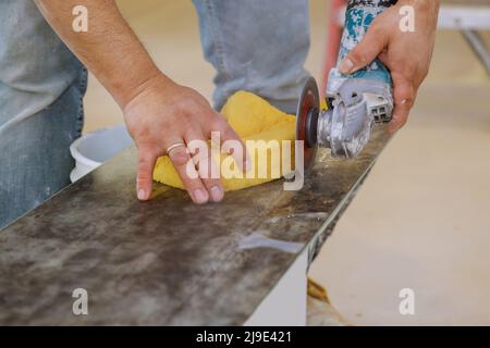 Worker hands cutting the floor ceramic tile by circular saw Stock Photo