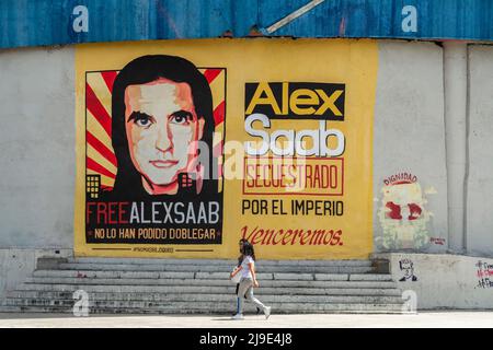 Caracas, Distrito Capital, Venezuela. 22nd May, 2022. Two women walk in front of a large mural calling for the release of Alex Saab on a street in Caracas, Venezuela. (Credit Image: © Jimmy Villalta/ZUMA Press Wire) Stock Photo