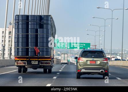 SAMUT PRAKAN, THAILAND, FEB 20 2022, A truck fully loaded with barrels ride on the highway Stock Photo