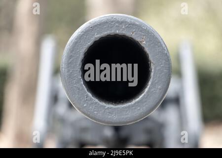 The barrel of the cannon aims front into a camera Stock Photo