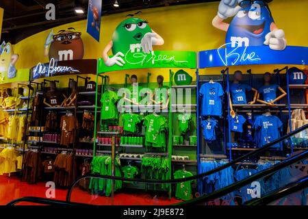 Variety of colored clothes and souvenirs . The MMs store in Manhattan. Stock Photo