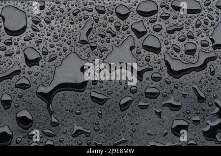 Water dropped on black marble after rain for background ang textured. Stock Photo