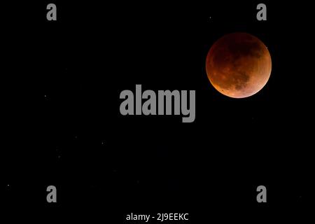 Moon and stars in the sky during the total moon eclipse May 15, 2022 Stock Photo