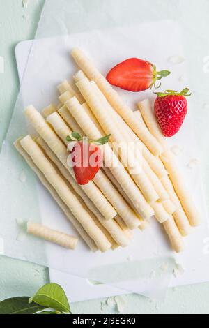 Heap of waffle rolls isolated on white background with strawberry Stock Photo