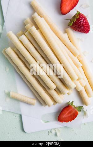 Heap of waffle rolls isolated on white background with strawberry Stock Photo