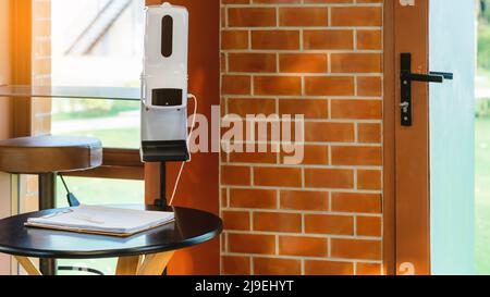Stand automatic alcohol dispenser spraying with automatic body thermometer check temperature for covid-19 pandemic for safety before entering the coff Stock Photo