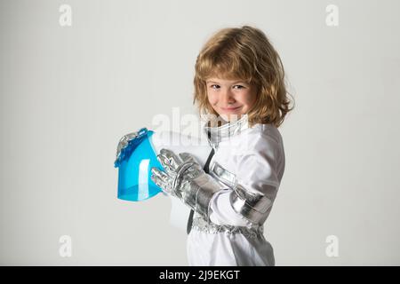 Space kids cosmonaut concept. Portrait of positive little boy wearing helmet with joy. Isolated background with copy space. Stock Photo