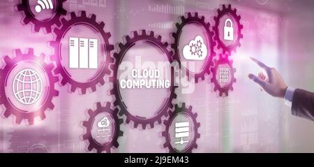 Cloud computing concept. Businessman is pressing on the virtual screen inscription Cloud computing Stock Photo