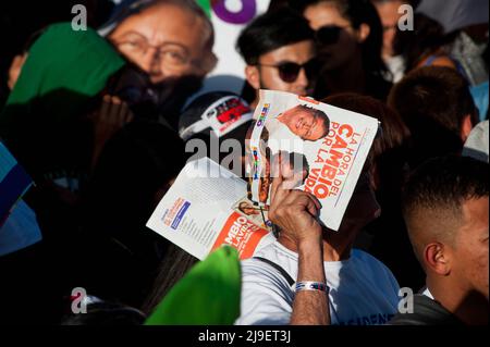 A supporter covers from the sun with a campaign banner during the closing campaign rally of left-wing presidential candidate for the political alliance 'Pacto Historico' Gustavo Petro,  in Bogota, Colombia on May 22, 2022. Photo by: Chepa Beltran/Long Visual Press Stock Photo