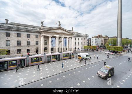 Luas tram passes in front of the GPO and Dublin Spire on a busy O'Connell Street, Dublin, Ireland Stock Photo