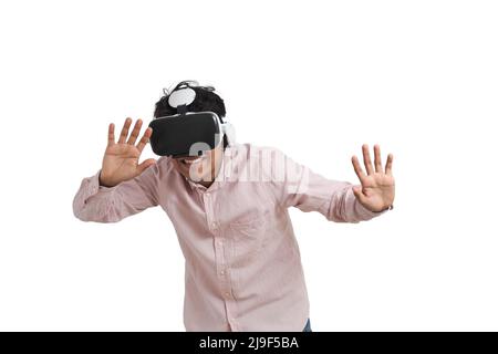 Young peruvian man laughing using virtual reality headset, isolated. Stock Photo