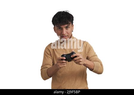 Young peruvian man playing video games with a joystick, isolated. Stock Photo