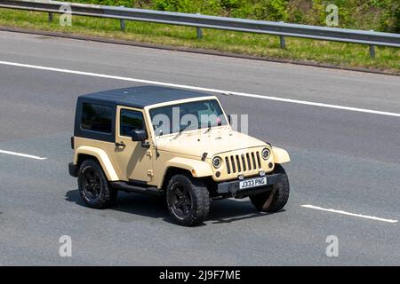 2007 beige Jeep Wrangler Sahara Sport CRD 175 Auto Soft Top 2777cc Diesel 4x4 SUV; driving on the M61 Motorway, Manchester, UK Stock Photo