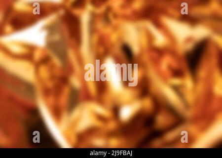 Blurred golden foil shimmer texture. Soft focus backdrop. Stock Photo