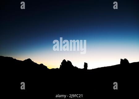 The Las Rochas rock formation at dusk in Teide National Park in Tenerife, Spain. The national park is renowned for the clarity of its sky. Stock Photo