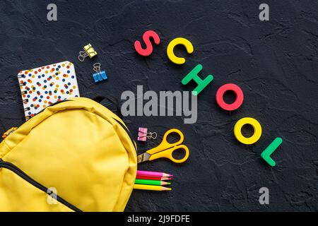 School backpack with school items and students equipment, top view Stock Photo