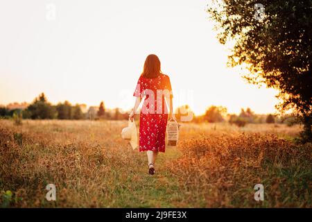 Connecting with nature benefits mental health. Nature Therapy Ecotherapy Helps Mental Health. Nature Impact Wellbeing. Woman in red dress enjoying Stock Photo