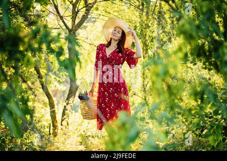 Connecting with nature benefits mental health. Nature Therapy Ecotherapy Helps Mental Health. Nature Impact Wellbeing. Woman in red dress enjoying Stock Photo