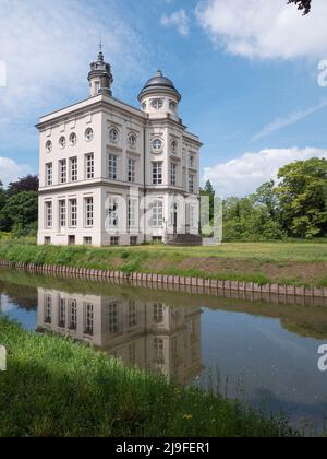 Beveren, Belgium, May 22, 2022, Side view of the Hof ter Saksen Castle with reflection in the water Stock Photo