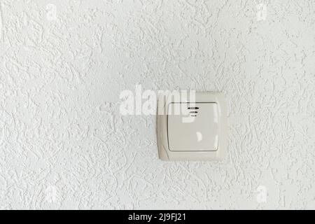 white light switch on empty wall with place for text modern look Stock Photo