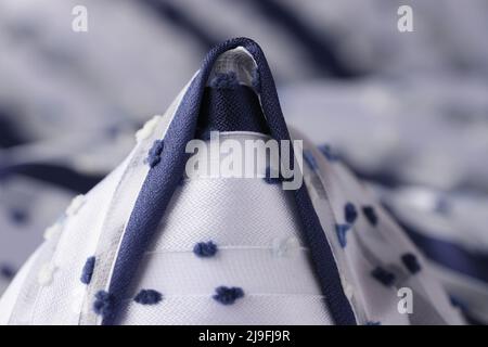White fabric with blue cone inserts closeup Stock Photo