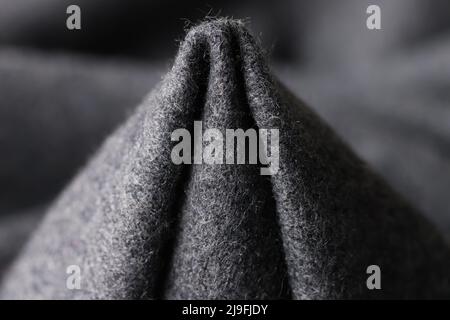 Dark gray woolen fabric in form of cone. Stock Photo