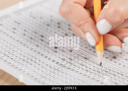Close up of hands of student doing test. Stock Photo