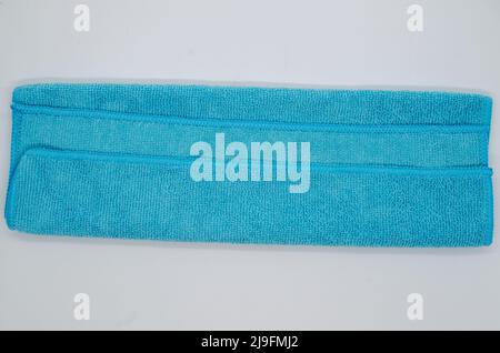 Isolated soft, fluffy, clean folded blue towel on white background Stock Photo