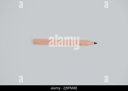 Single isolated small wooden drawing pencil, for student and children on white background Stock Photo