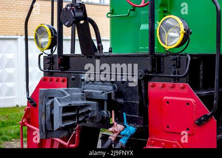 Two electric headlights on a retro train front on the rail platform close up. Stock Photo