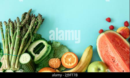 Fruits, berries and vegetables on a blue background. Stock Photo