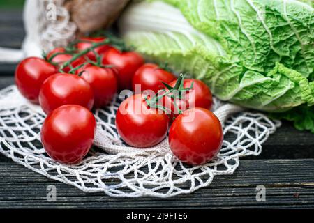 Close-up of tomatoes on a wooden surface. Stock Photo