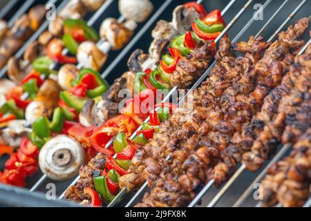Skewered meat and vegetables being grilled. Stock Photo