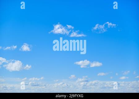 Blue sky with white cumulus clouds. Bright sunny day with cloudy sky Stock Photo