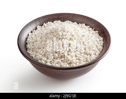 Uncooked arborio rice in ceramic bowl isolated on white background with clipping path Stock Photo