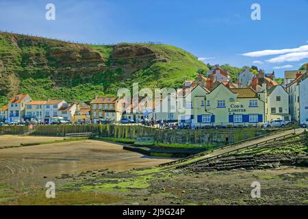 Harbour and village with the 'Cod & Lobster' Inn at Staithes, North Yorkshire, England. Stock Photo