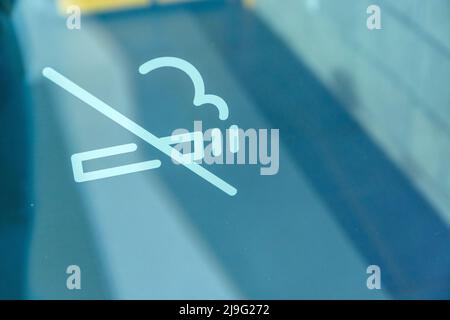 No smoking sign painted on the window of the premises, close up Stock Photo