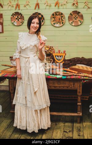 Beautiful young woman in an old white dress Stock Photo