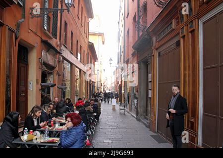 Bologna, Italy. Outdoor seating area of a local restaurant on one of the narrow streets in the historical center. Stock Photo