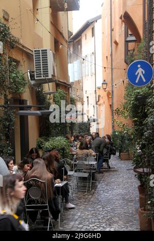 Bologna, Italy. Outdoor seating area of a local restaurant on one of the narrow streets in the historical center. Stock Photo