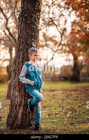 Young man pose and turning back upon camera with a beautiful green scenery  of park on background Stock Photo - Alamy