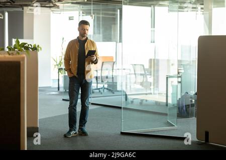 Cheerful Businessman Using Digital Tablet Computer Entering Modern Office Stock Photo