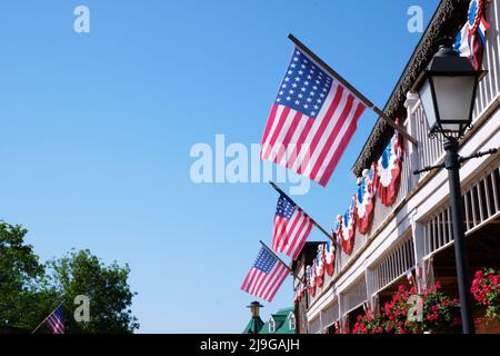 Profuse American patriotic decorations with flags bunting  and garlands in the nation's colors on the balconies of southern mansions Stock Photo