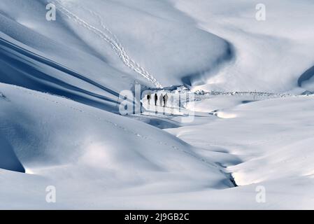 people walking on a snow hill Stock Photo