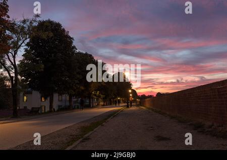 Sunset over the Medieval tree lined walls surrounding Lucca Old Town Stock Photo